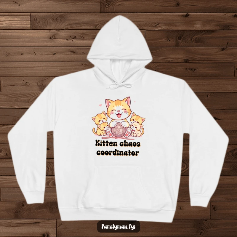 Funny hoodie featuring a joyful cat playfully entangled with a ball of yarn, surrounded by a playful group of kittens, offering cozy comfort.