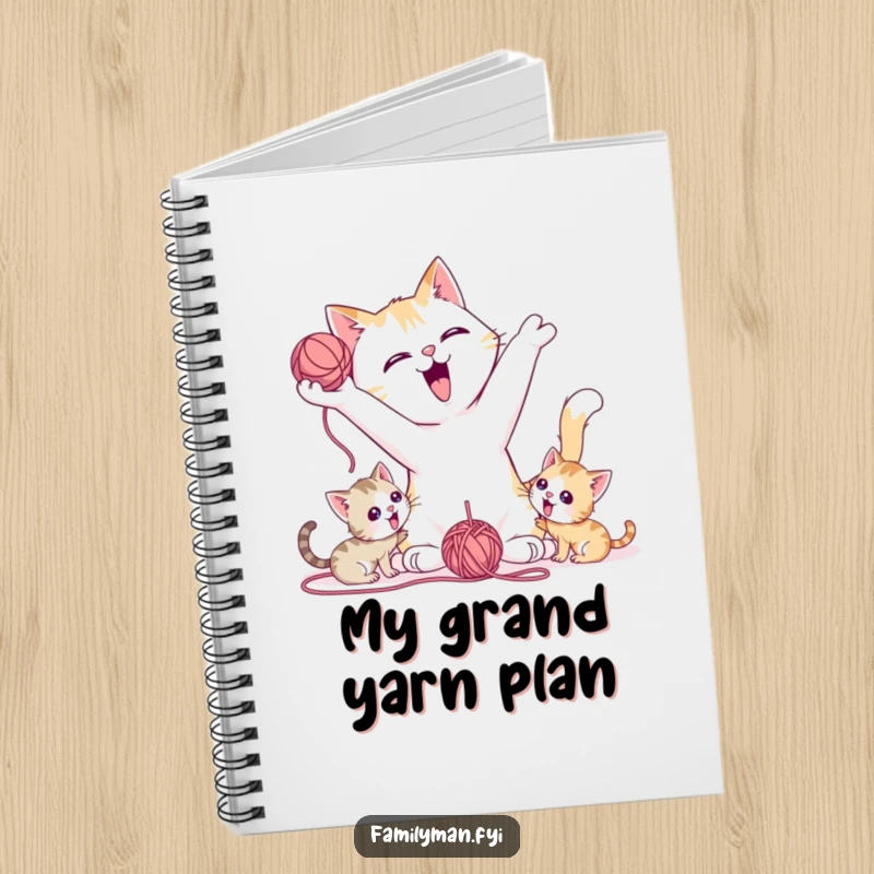 Funny Notebook with a playful father cat tossing a yarn ball for kittens, ready for notes on fun.